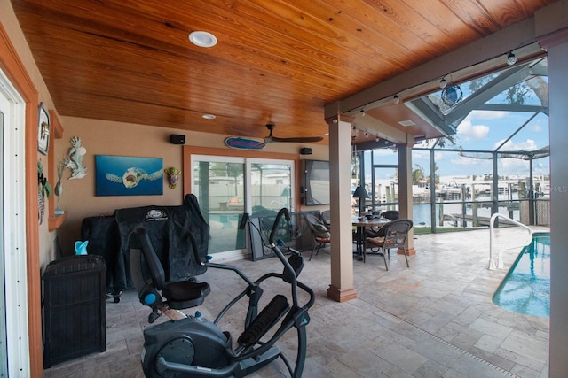 exercise area with ceiling fan, a water view, wooden ceiling, and a swimming pool