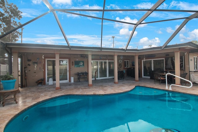 view of swimming pool featuring a lanai and a patio area