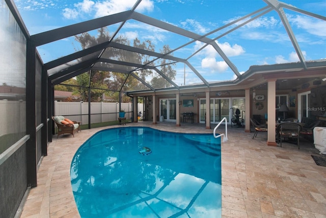 view of swimming pool with a patio and a lanai