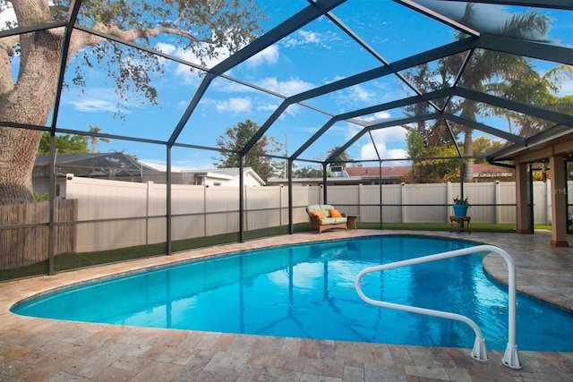 view of swimming pool with a patio area and a lanai