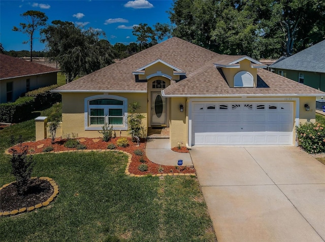 ranch-style house with a front yard and a garage