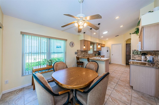 dining space with ceiling fan and lofted ceiling