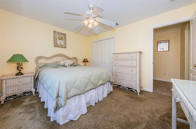 carpeted bedroom featuring ceiling fan and a closet