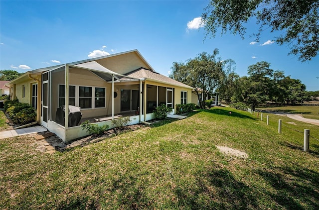 rear view of house featuring a yard