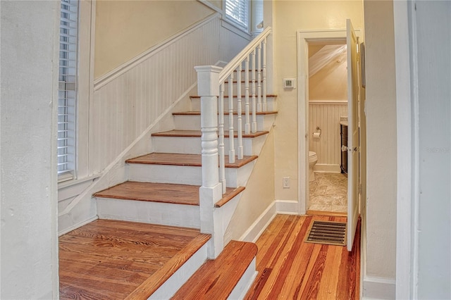 staircase with hardwood / wood-style flooring