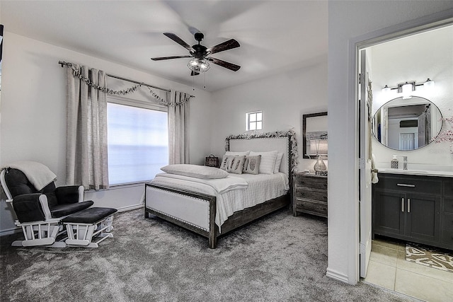 bedroom with ceiling fan, carpet floors, and ensuite bath