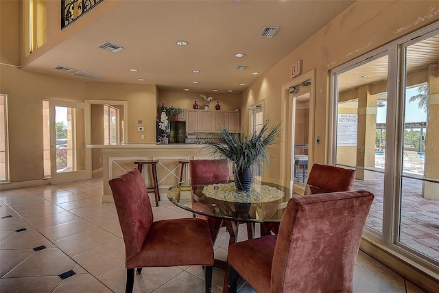 dining space featuring light tile patterned floors