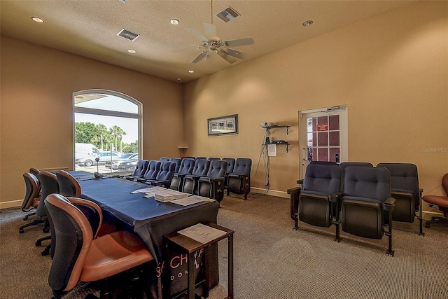 dining area with ceiling fan, carpet flooring, and a textured ceiling