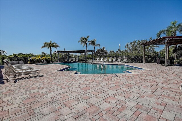 view of swimming pool with a patio area and a pergola