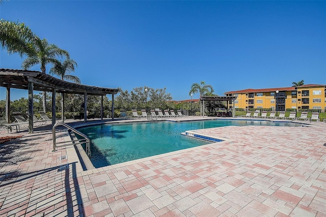 view of pool with a patio and a pergola