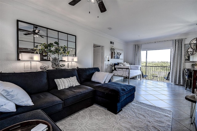 living room with tile patterned floors, ornamental molding, and ceiling fan