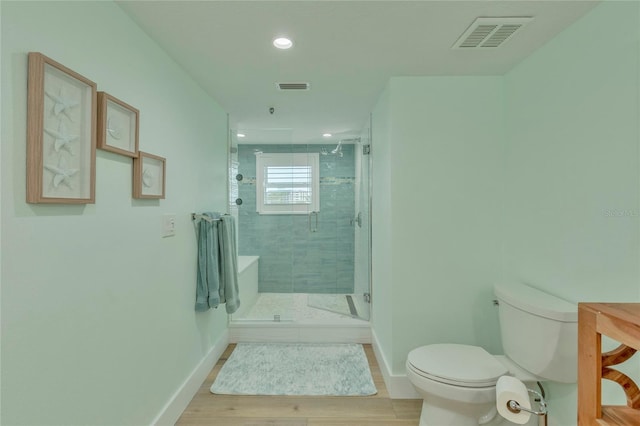 bathroom with an enclosed shower and toilet