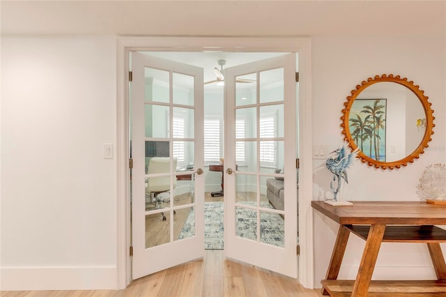 doorway with light wood-type flooring and french doors