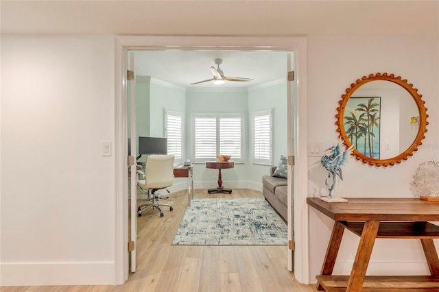 interior space with ceiling fan, light hardwood / wood-style floors, and crown molding