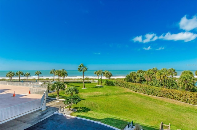 view of swimming pool featuring a water view and a yard