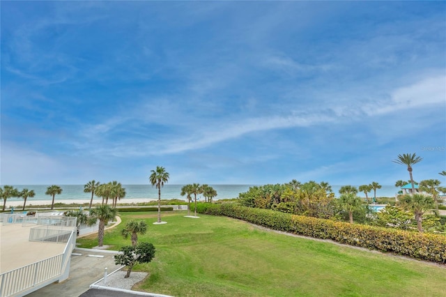 surrounding community featuring a water view and a lawn