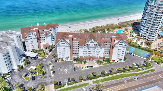 birds eye view of property with a view of the beach and a water view