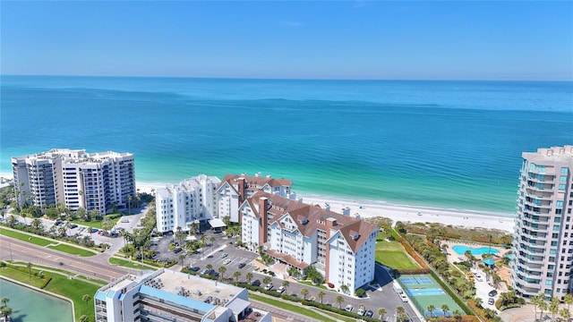 birds eye view of property featuring a water view and a beach view