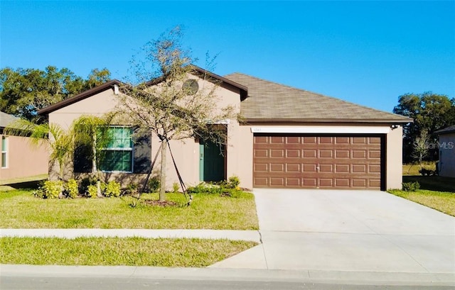 view of front of property with a garage and a front lawn