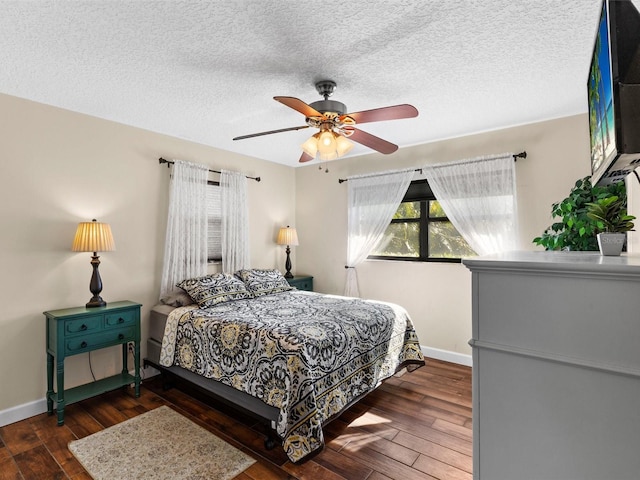 bedroom featuring ceiling fan, a textured ceiling, and dark hardwood / wood-style floors