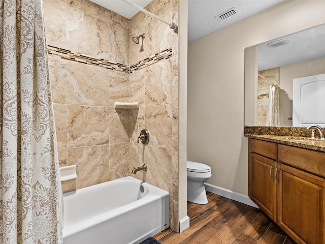 full bathroom with toilet, vanity, and shower / bath combo with shower curtain