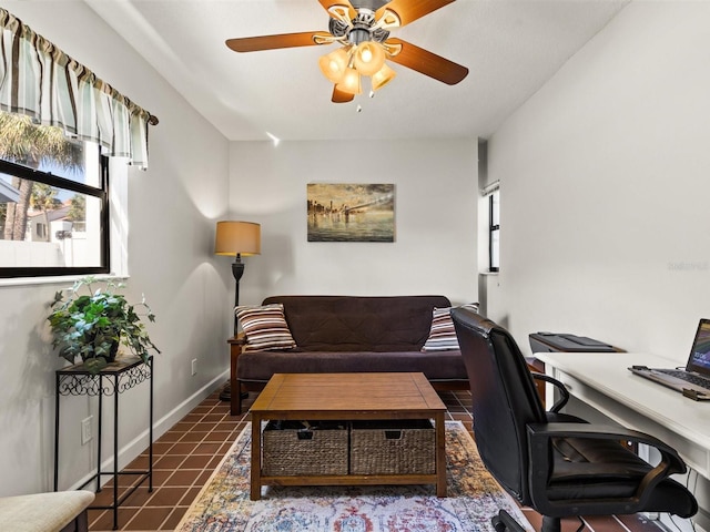 tiled office space featuring ceiling fan