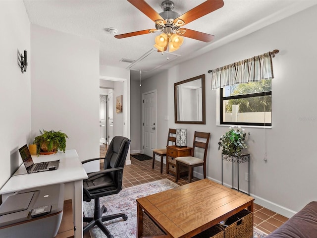 home office featuring a textured ceiling and dark tile patterned flooring