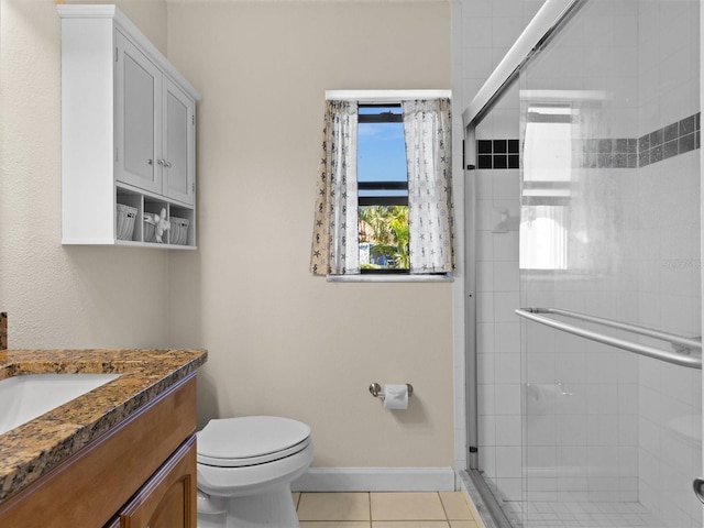 bathroom with toilet, tile patterned floors, walk in shower, and vanity