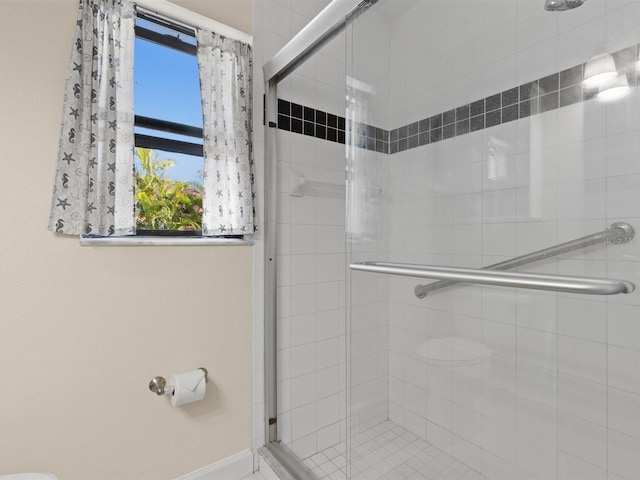 bathroom featuring a shower with shower door