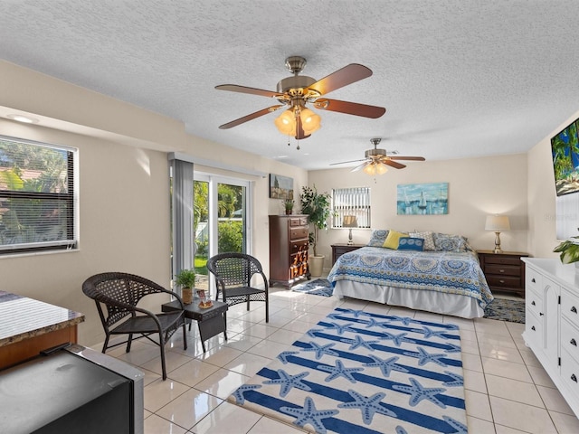 bedroom with a textured ceiling, ceiling fan, and light tile patterned flooring