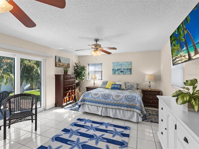 bedroom with ceiling fan, access to exterior, a textured ceiling, and light tile patterned floors