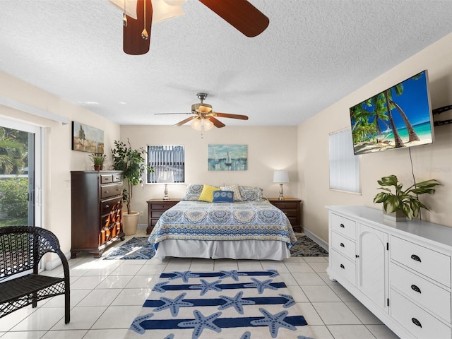 tiled bedroom with a textured ceiling and ceiling fan