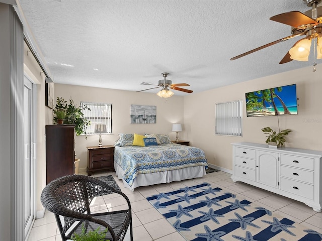 tiled bedroom featuring a textured ceiling and ceiling fan