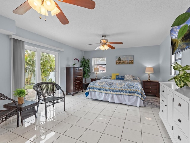 bedroom with light tile patterned flooring, a textured ceiling, and ceiling fan