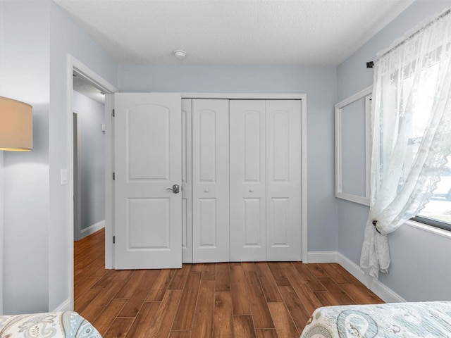 bedroom with wood-type flooring and a closet