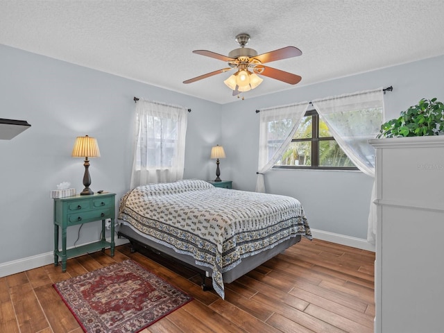 bedroom featuring a textured ceiling, ceiling fan, and hardwood / wood-style flooring