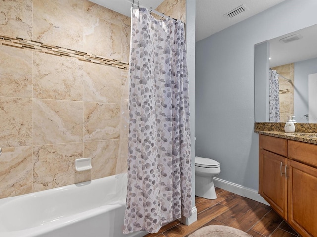 full bathroom featuring shower / bathtub combination with curtain, vanity, and toilet