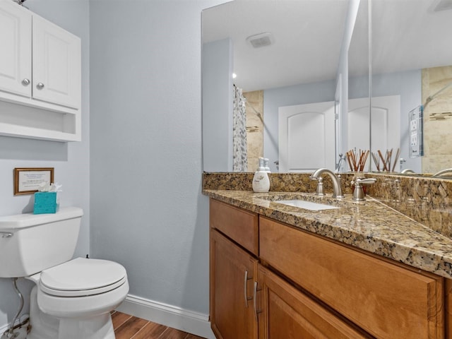 bathroom with toilet, vanity, and a shower with curtain