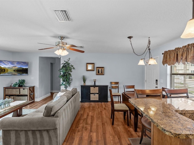 living room featuring ceiling fan and hardwood / wood-style flooring