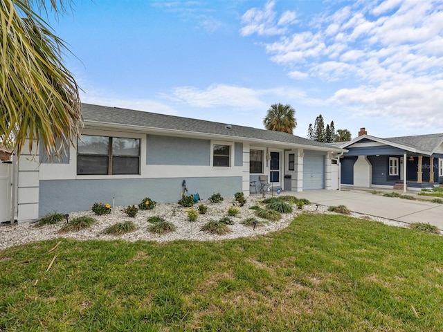 ranch-style home with a front lawn and a garage