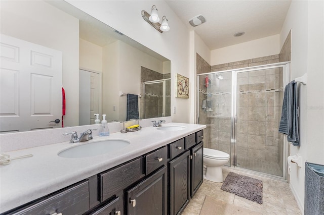 bathroom with vanity, an enclosed shower, and toilet