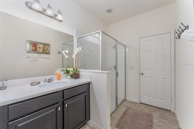 bathroom featuring tile patterned flooring, vanity, and an enclosed shower