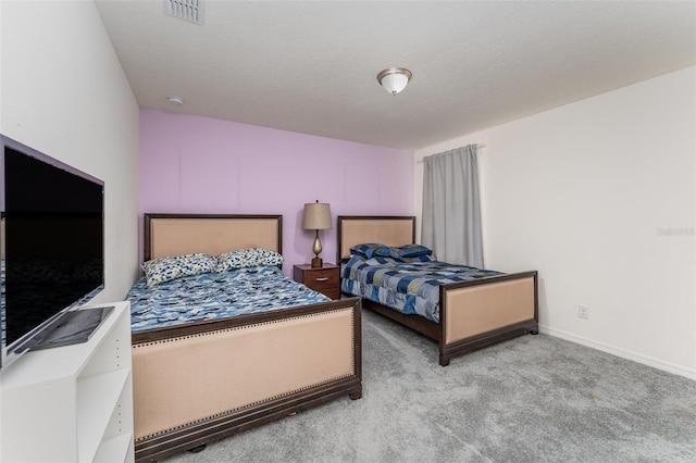 bedroom featuring carpet and a textured ceiling