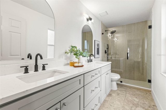 bathroom featuring vanity, toilet, and an enclosed shower