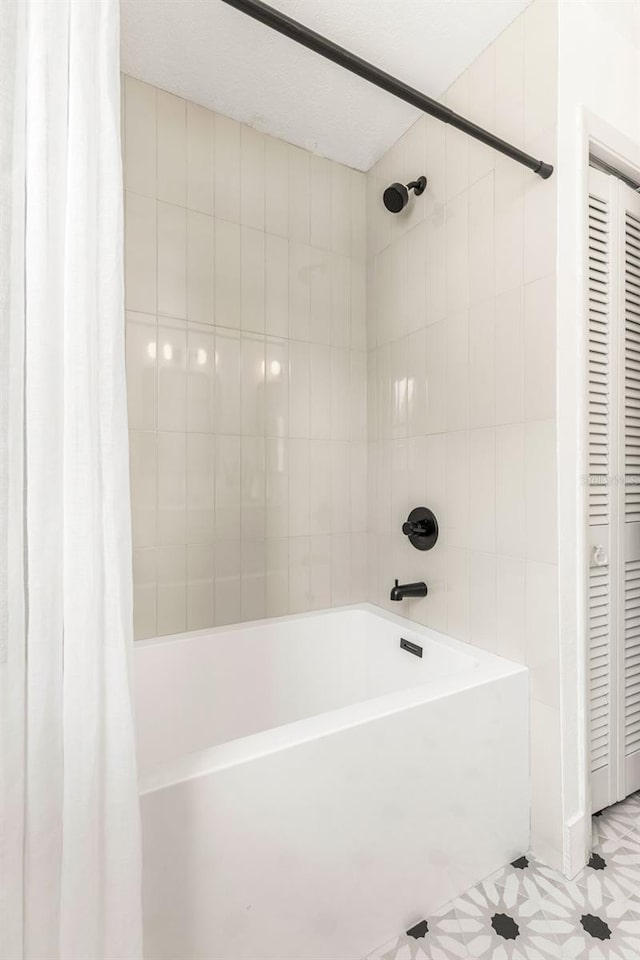 bathroom featuring tile patterned flooring and shower / bathtub combination with curtain