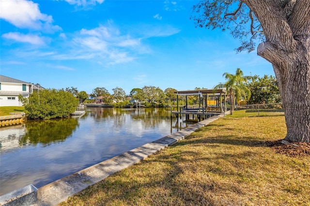 view of dock featuring a water view and a yard