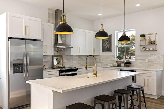 kitchen featuring stainless steel appliances, white cabinetry, sink, and wall chimney exhaust hood