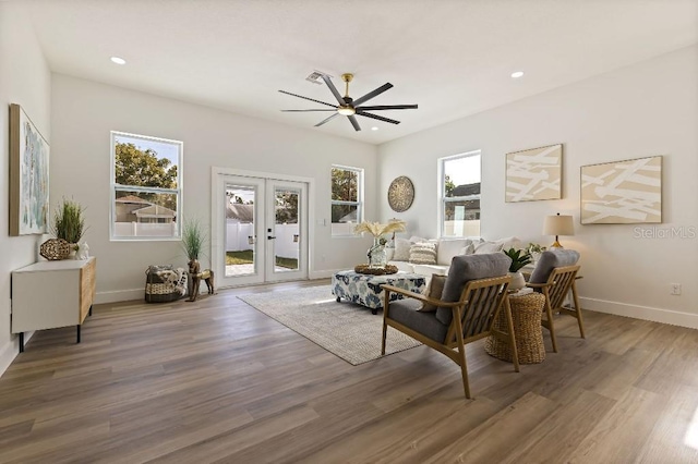 living room featuring hardwood / wood-style floors, french doors, and ceiling fan