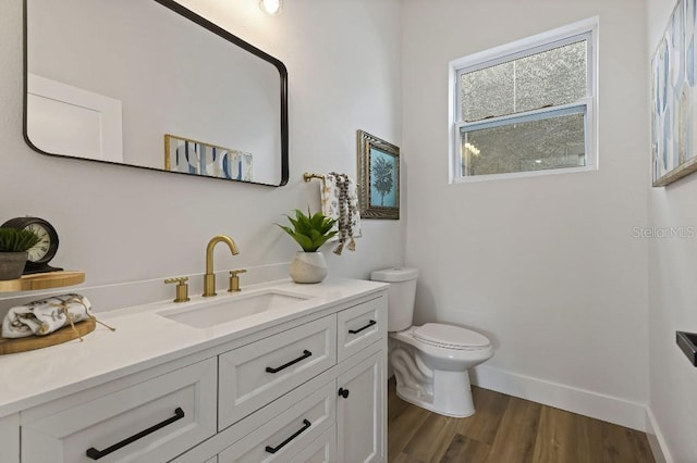 bathroom featuring vanity, hardwood / wood-style floors, and toilet