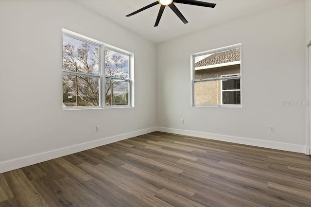 unfurnished room with dark hardwood / wood-style flooring and ceiling fan